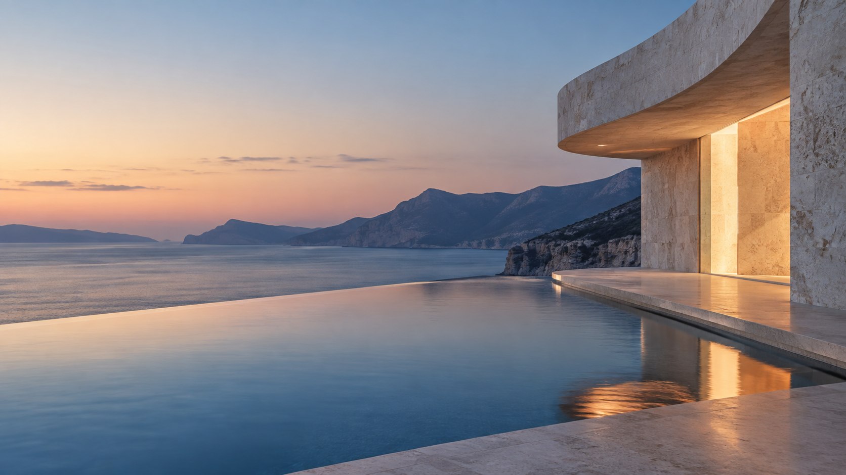Pavilhão de pedra diante de uma piscina e do horizonte ao entardecer
